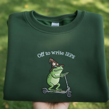 Off To Write IEPS Embroidered Sweatshirt, Frog On Scooter Special Education Shirt, Funny SPED Teacher Crewneck, Aesthetic Green Frog Shirt